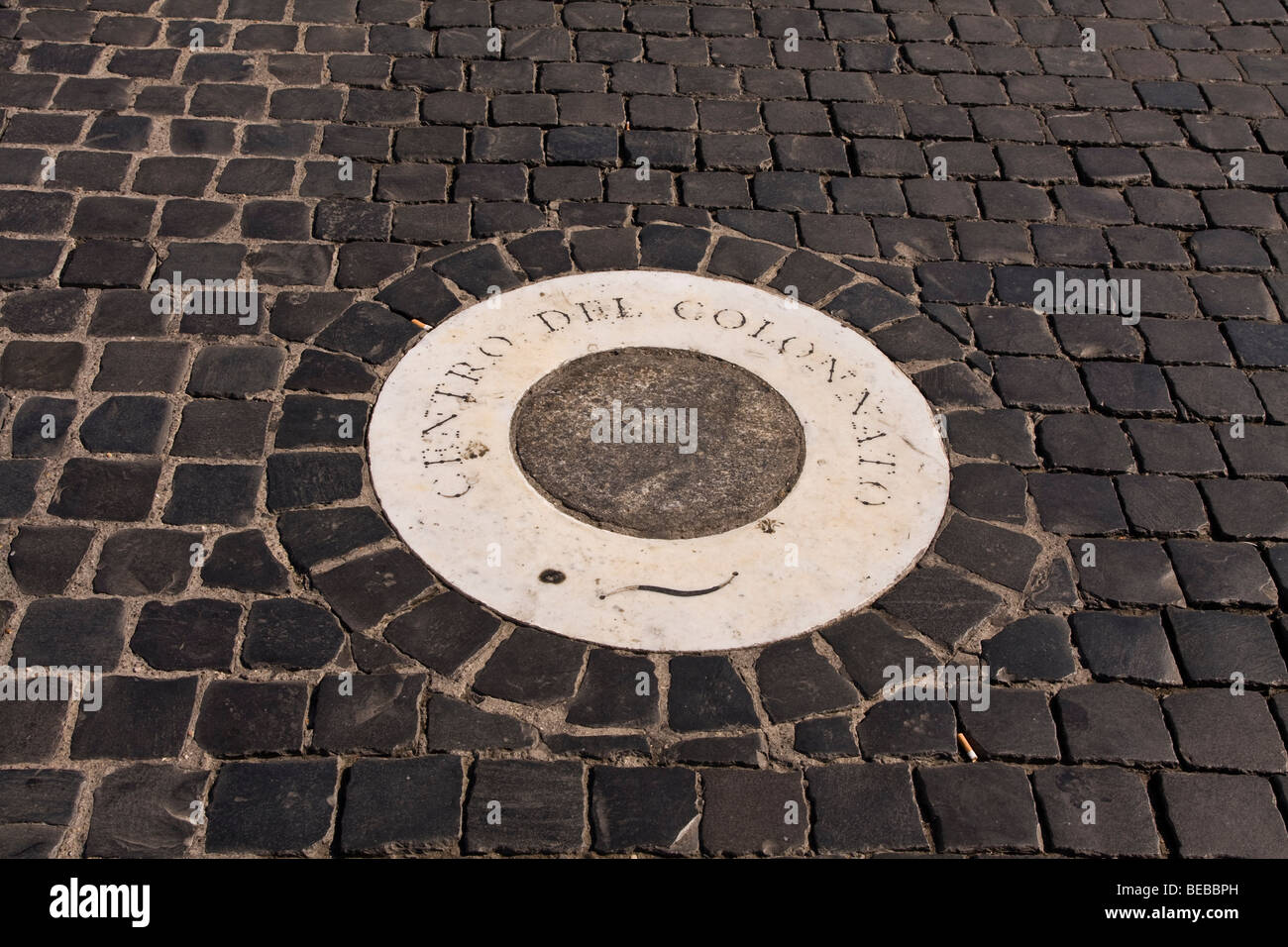 Marker tile at the centre point of Bernini`s colonnade in St Peter`s square in Rome Italy Stock Photo